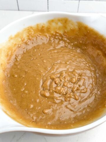 wet ingredients for banana blondies mixed in a white mixing bowl.