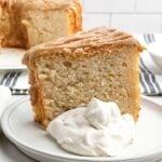 a piece of cake mix banana angel food cake on a plate with cinnamon whipped cream.