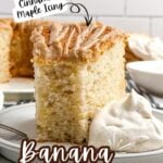 a piece of banana angel food cake with a bite removed on a plate with cinnamon whipped cream.