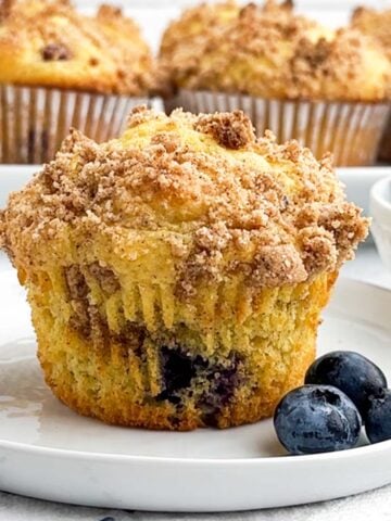 a cake mix blueberry muffin on a white plate.