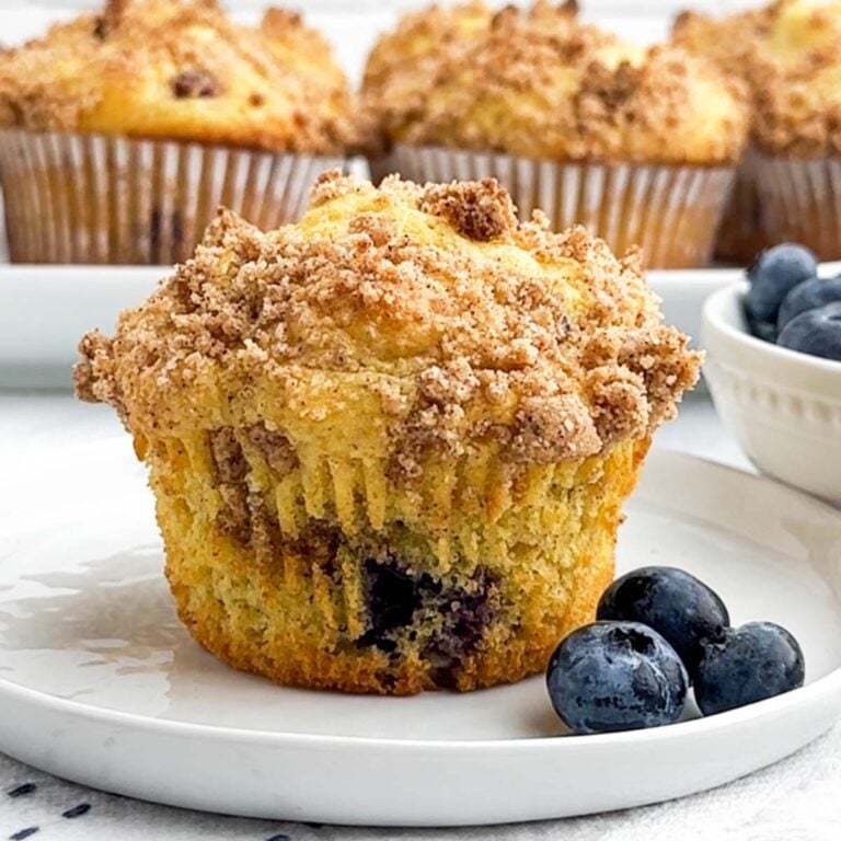 a cake mix blueberry muffin on a white plate.