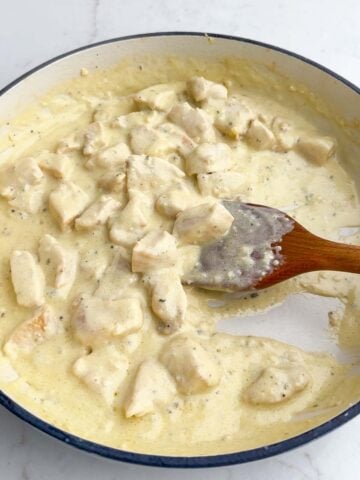 cooked chicken and Boursin sauce in a Dutch oven.