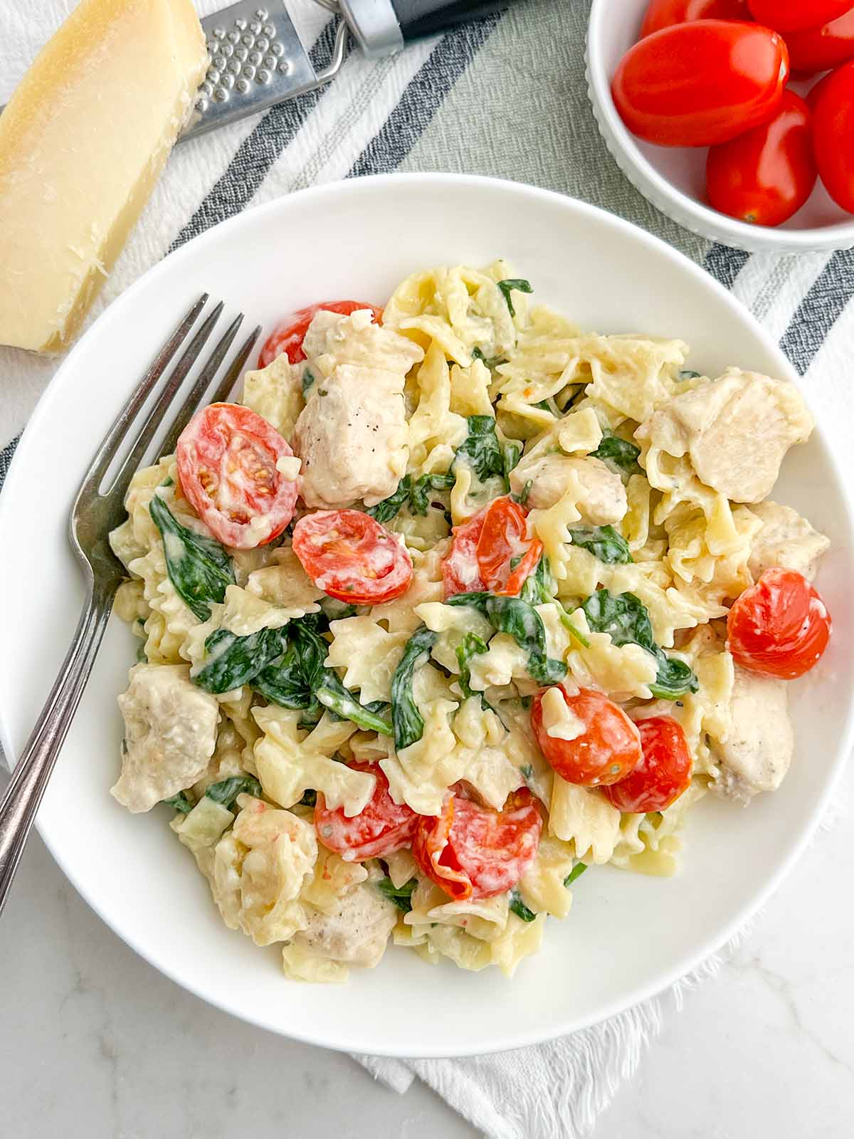 chicken Boursin pasta on a white plate.