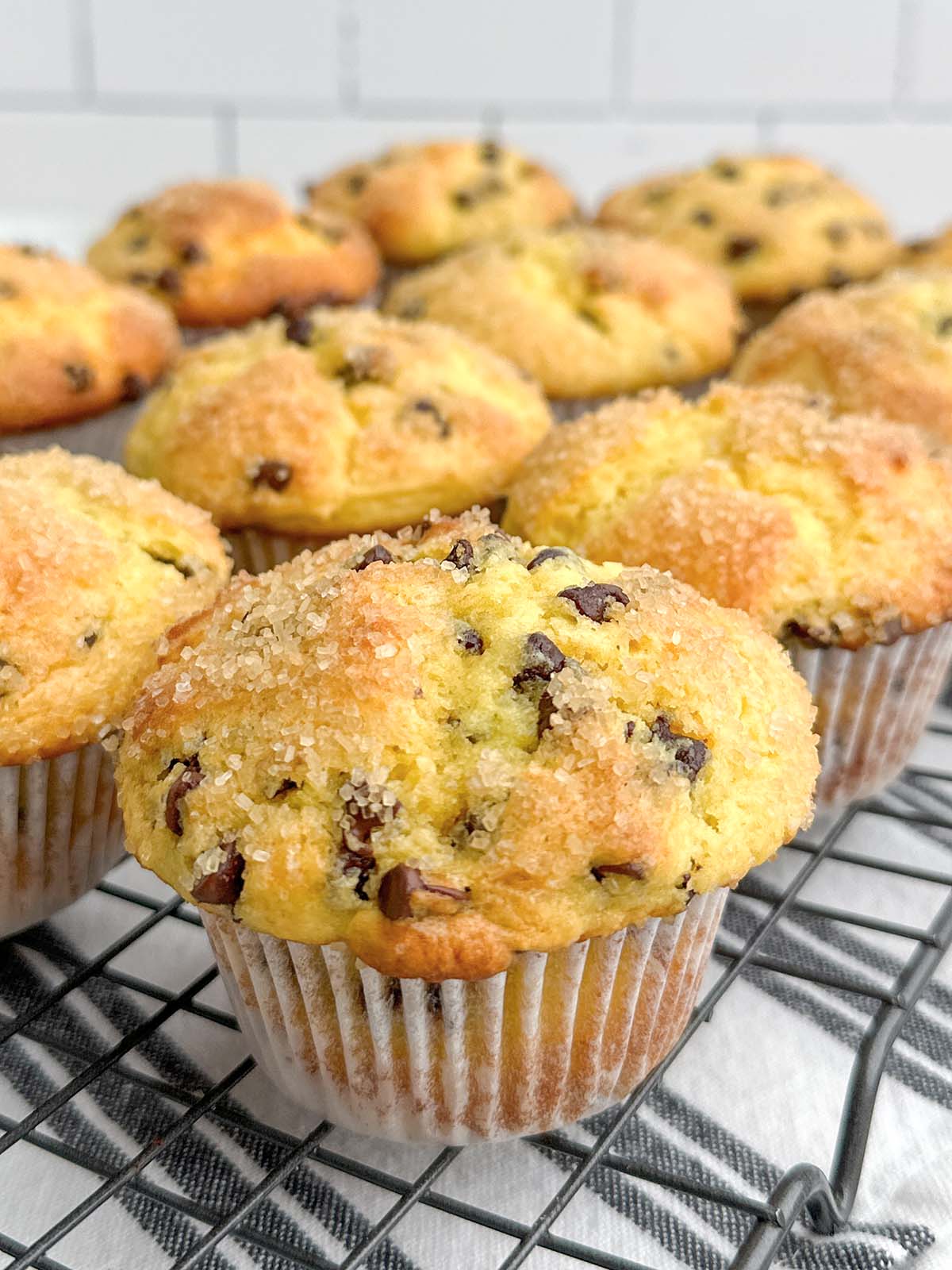 baked chocolate chip cake mix muffins on a wire rack.