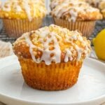 lemon cake mix muffin with lemon streusel and lemon glaze on a white plate.
