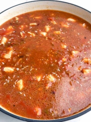 Mexican chicken and rice cooking in a Dutch oven.