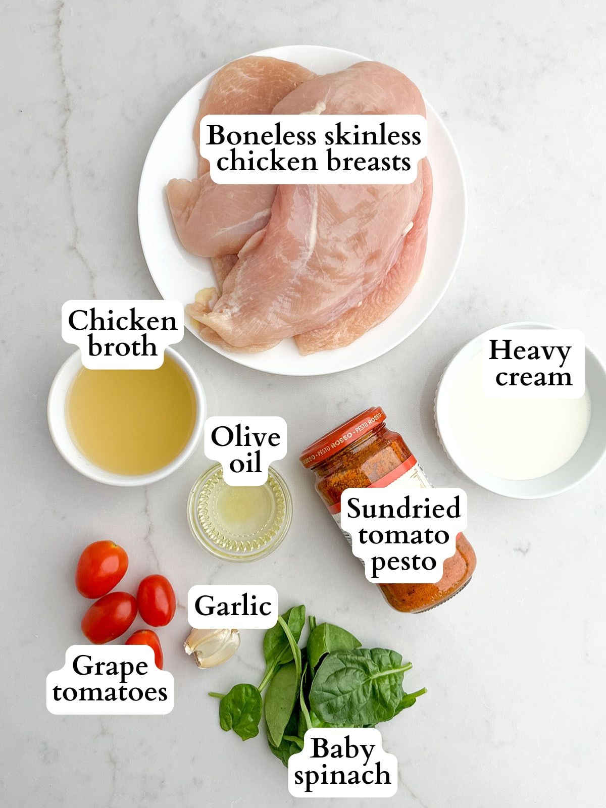sundried tomato pesto chicken ingredients on a white countertop.