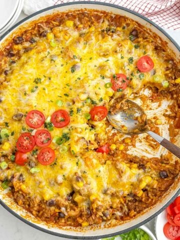 cheesy ground beef salsa rice with beans and corn in a Dutch oven.