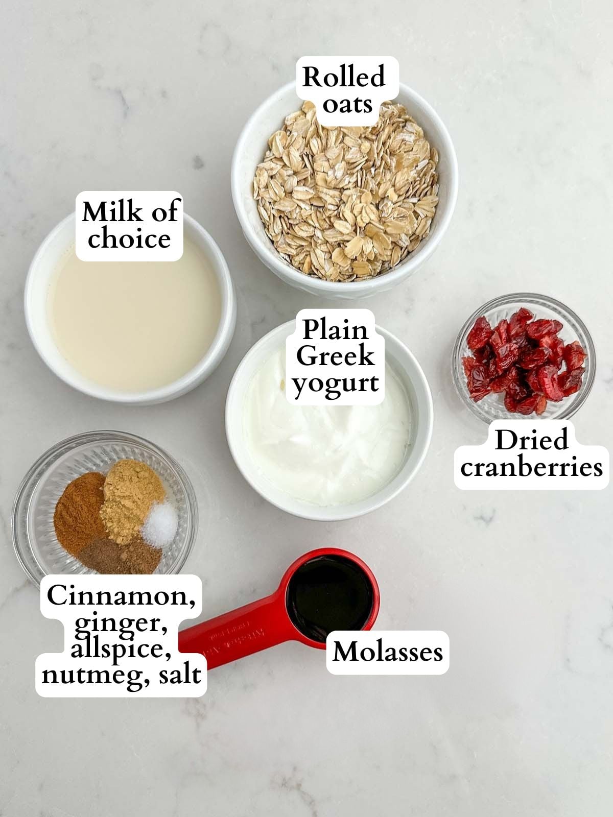 gingerbread overnight oats ingredients on a white countertop.