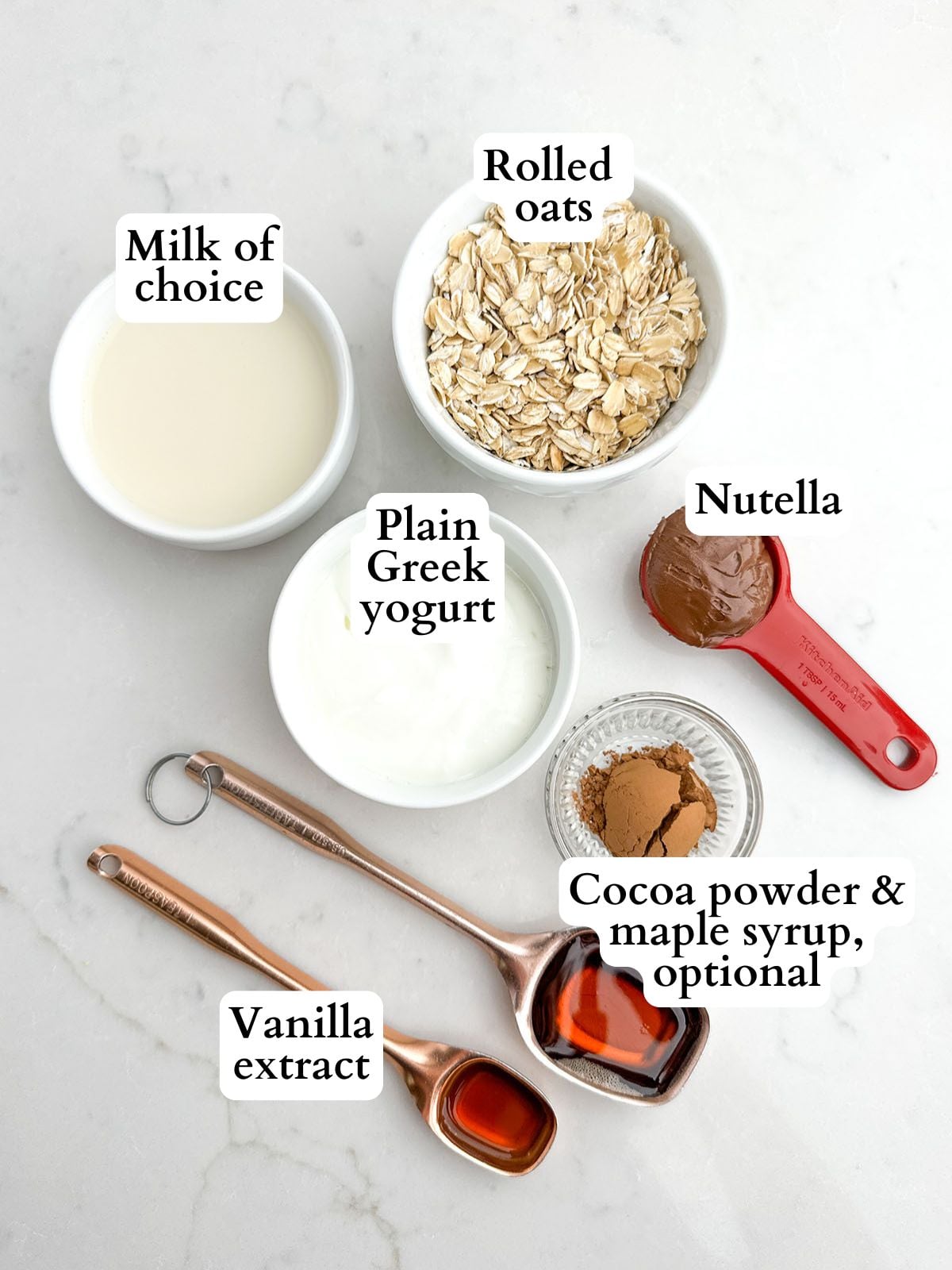 Nutella overnight oats ingredients on a white countertop.