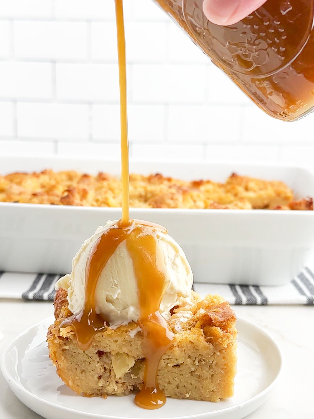 pineapple pudding topped with vanilla ice cream and caramel whiskey sauce.