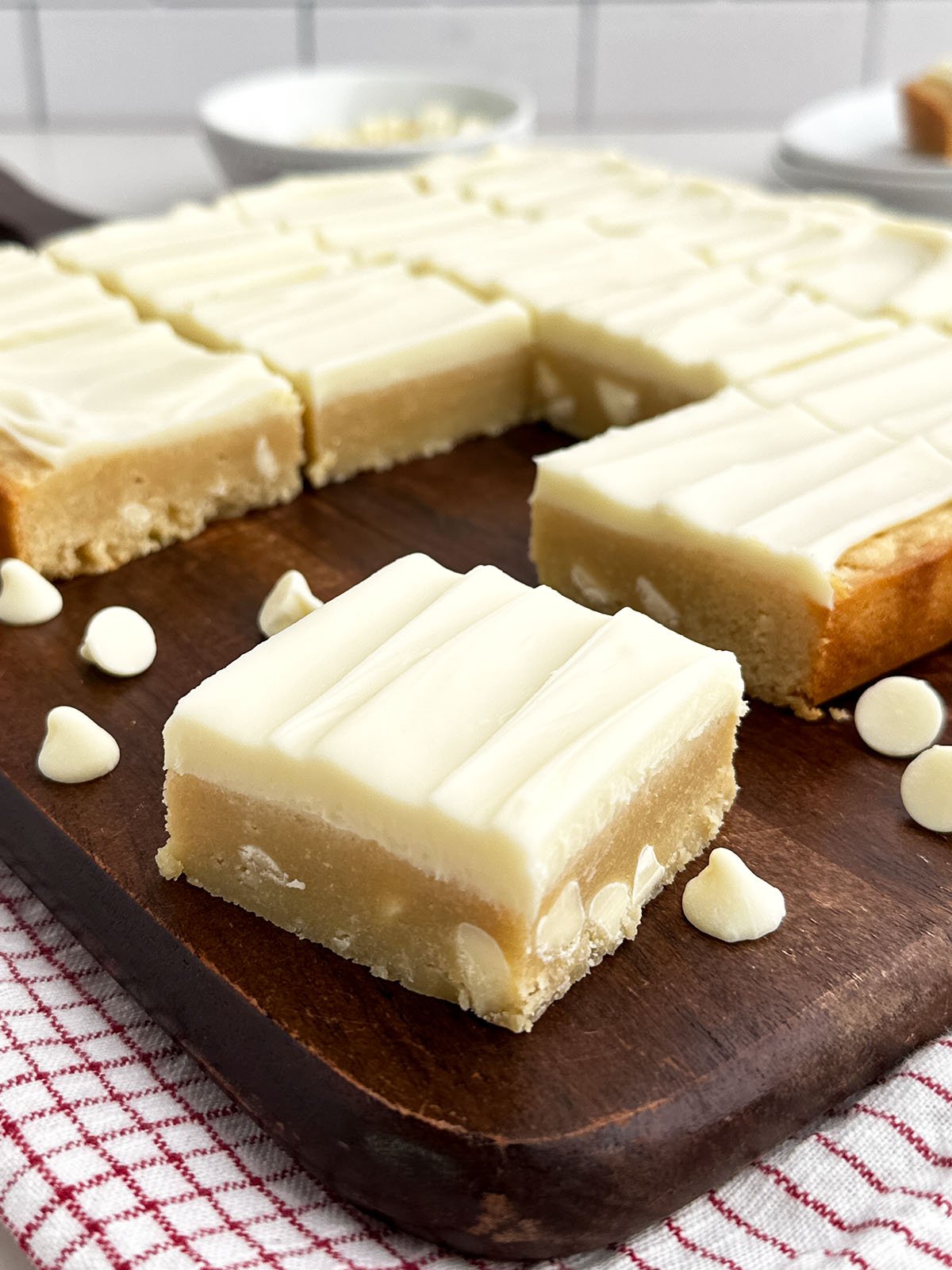 white chocolate brownies on a wooden cutting board.