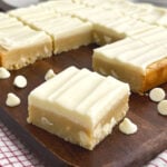 white chocolate brownies on a wooden cutting board.