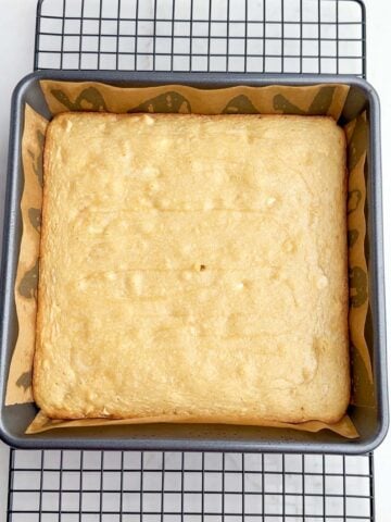 baked white chocolate brownies in a square baking pan.