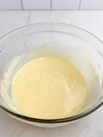 melted white chocolate chips and butter in a clear bowl.