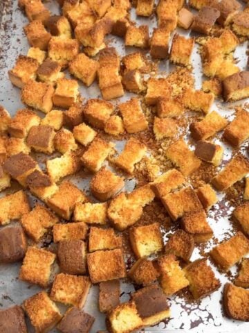 toasted cornbread cubes on a baking sheet.