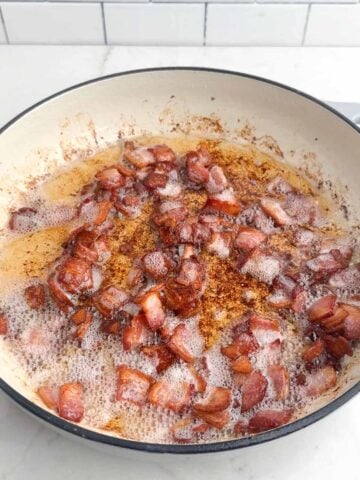 bacon frying in a Dutch oven.