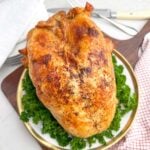 roast bone-in turkey breast on a white plate.