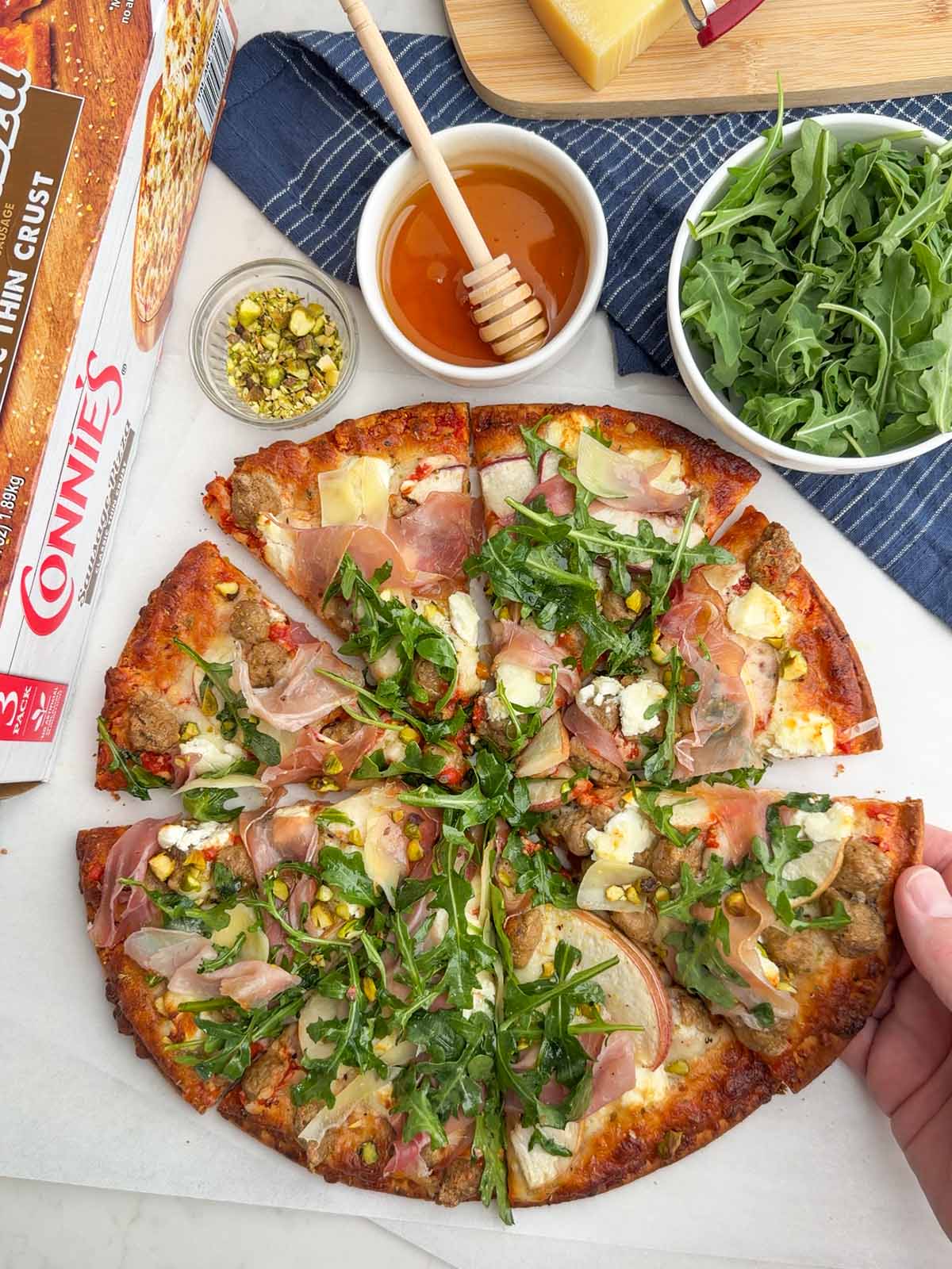 nectarine prosciutto pizza with arugula salad made with a frozen sausage pizza.