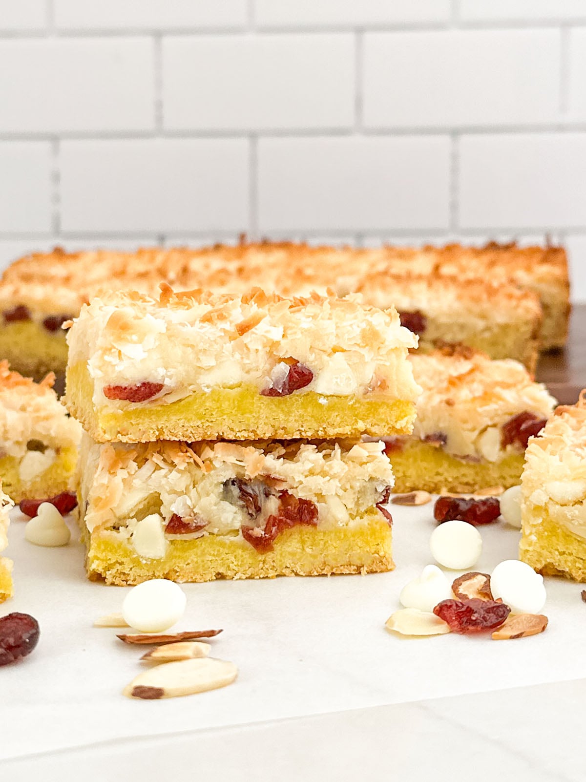 a stack of lemon cake mix cookie bars on a white countertop.