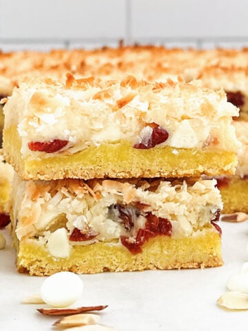 a stack of lemon cake mix white chocolate cookie bars on a white countertop.