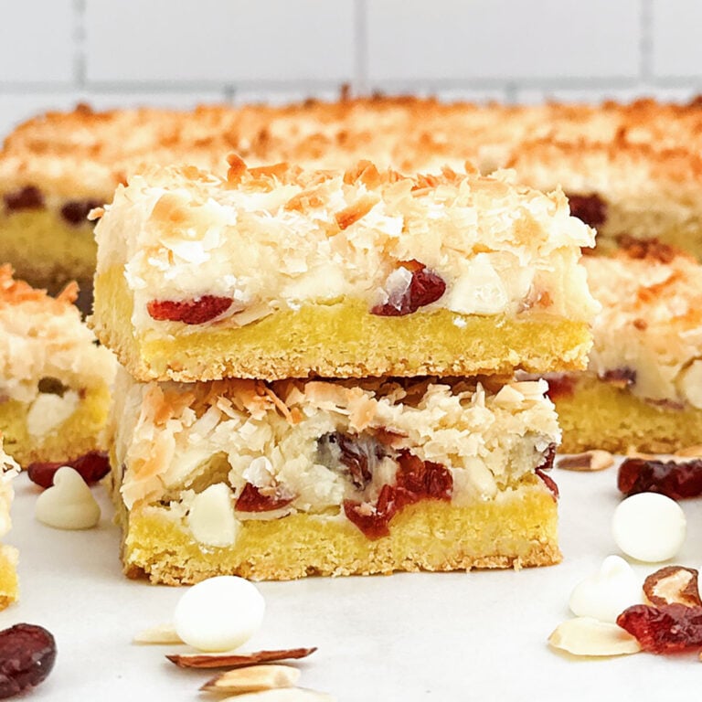 a stack of lemon cake mix white chocolate cookie bars on a white countertop.