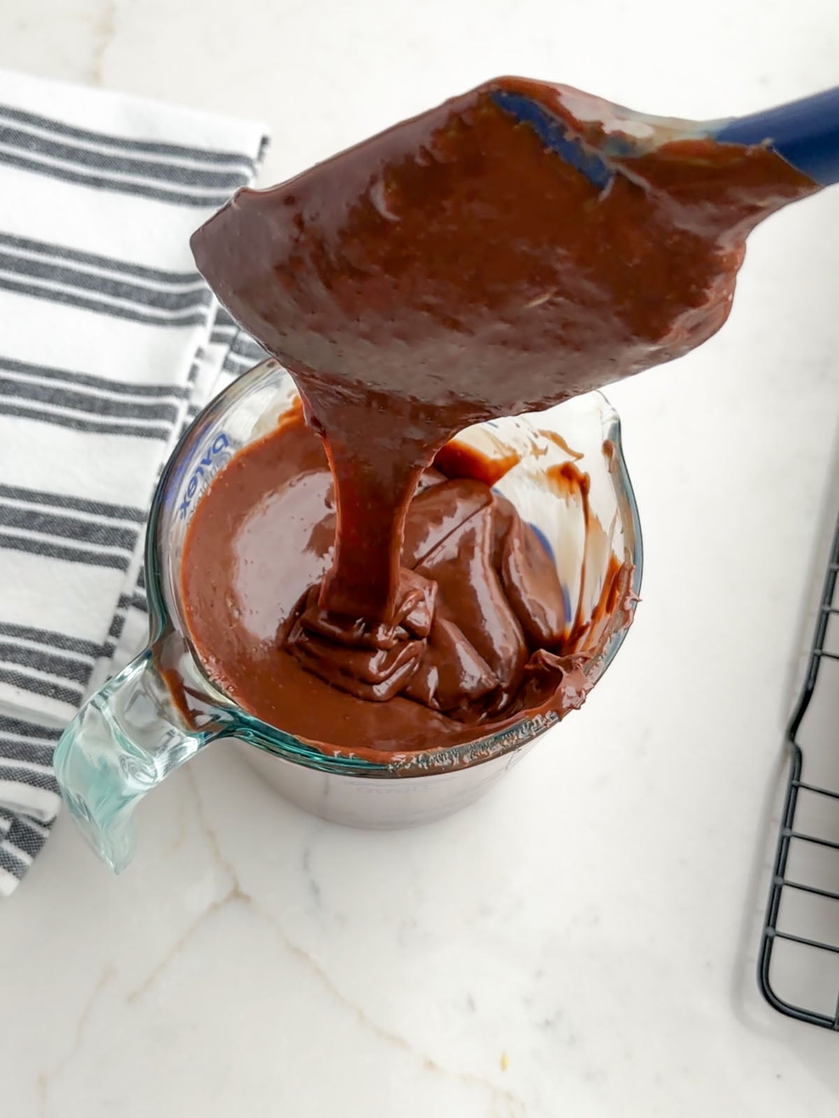 melted chocolate and condensed milk in a glass measuring cup.
