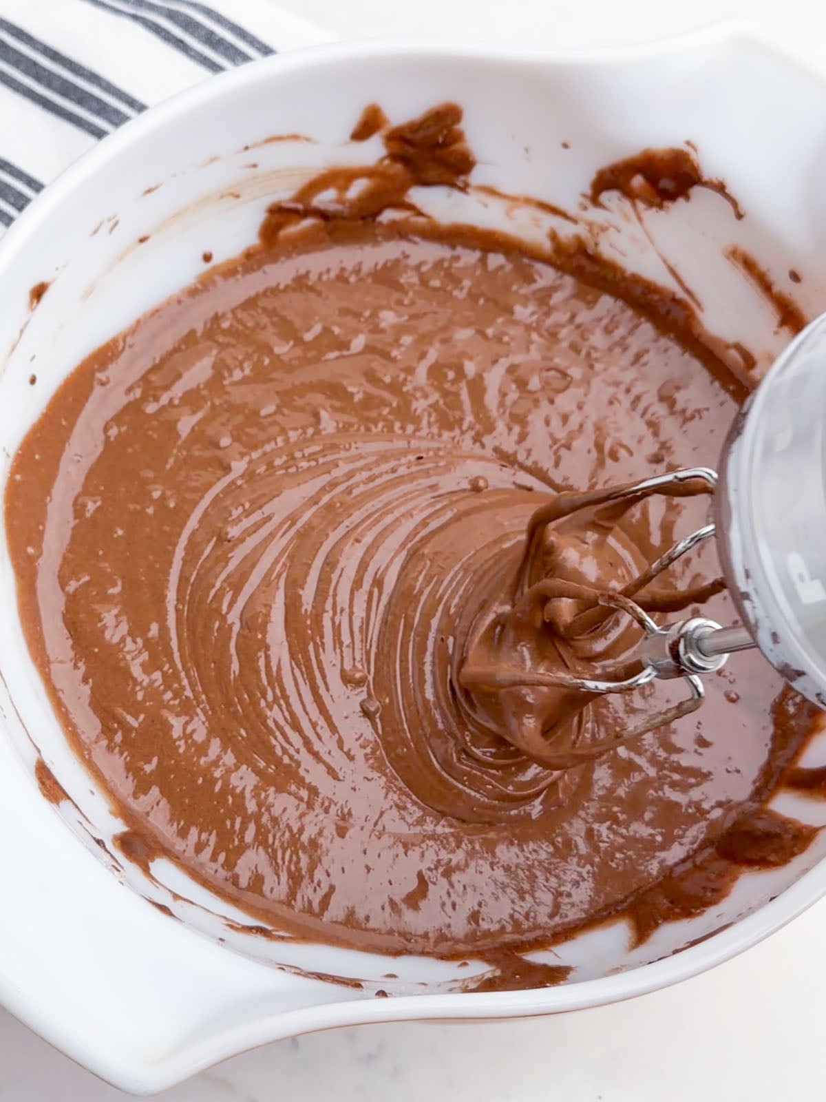 mixer mixing chocolate cake batter.