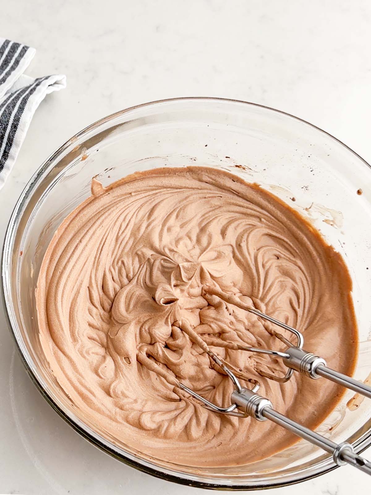 chocolate whipped cream in a clear bowl.