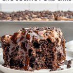 piece of chocolate poke cake on a white plate.